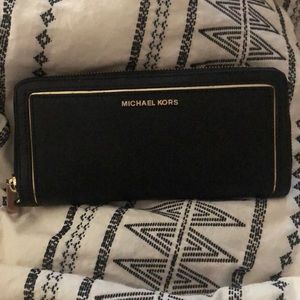 Micheal Kors black zip around wallet.